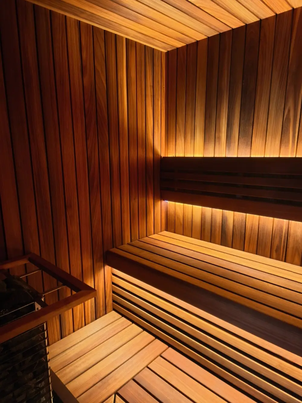 Thermo Abachi cladding installed in a sauna interior, with benches and a heater.