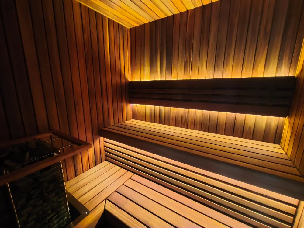 Thermo Abachi cladding and benches in a sauna interior.